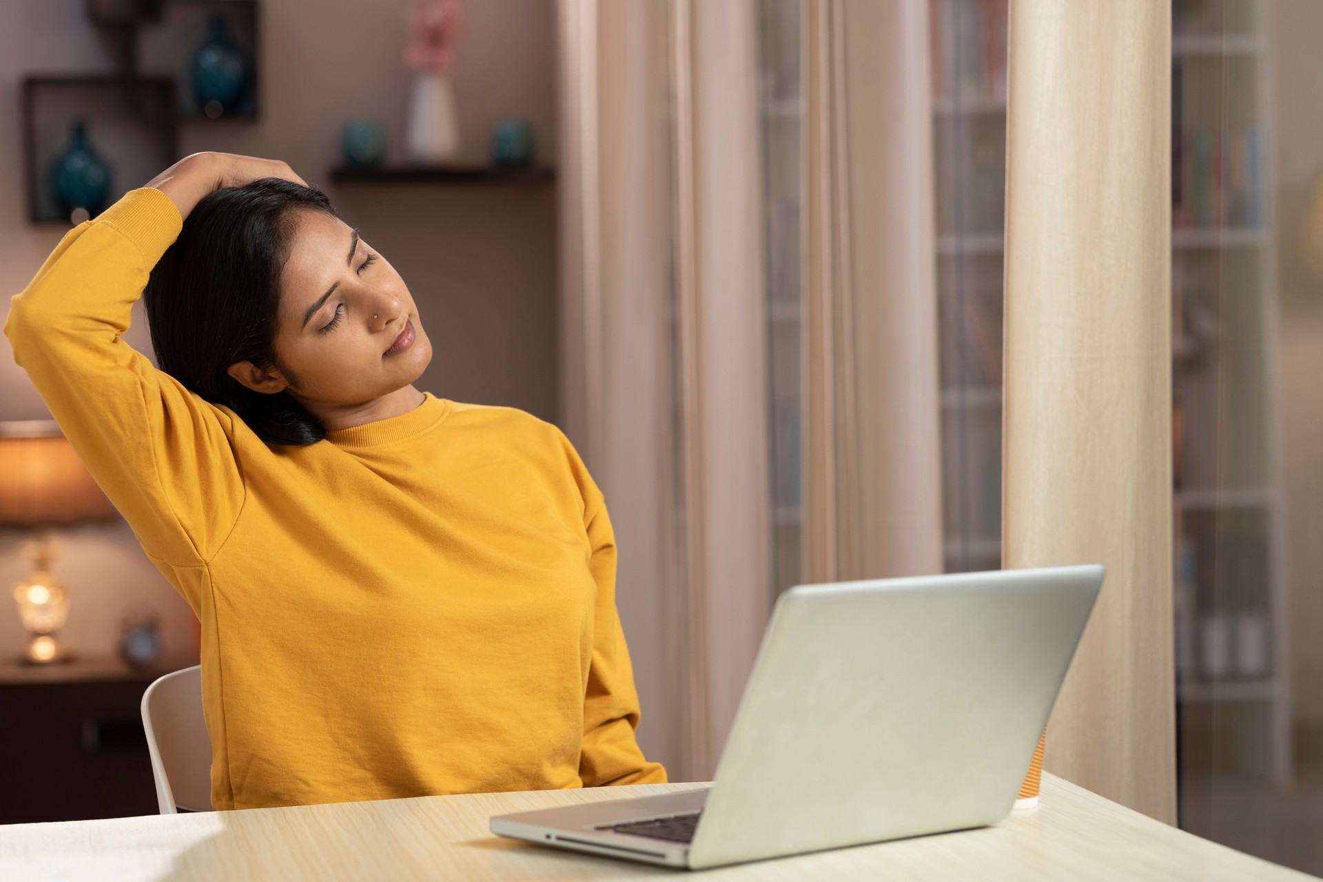 young businesswoman Stretching Her neck while working at home